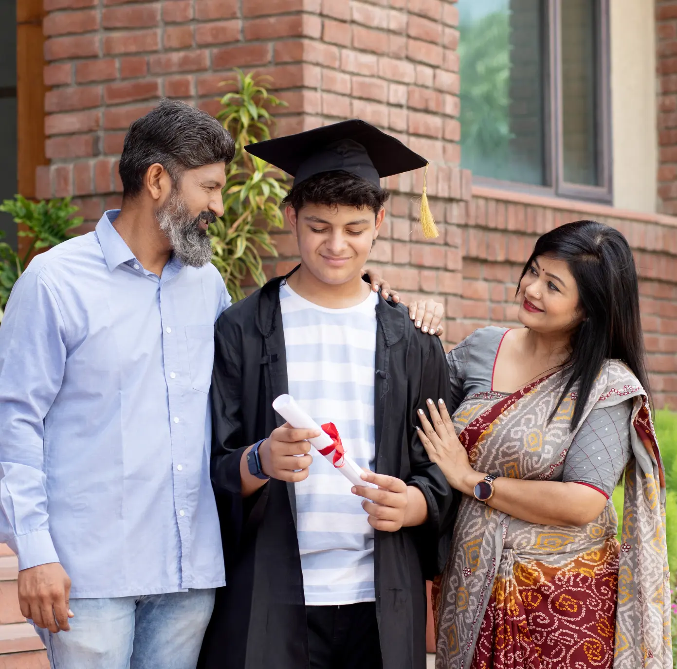 Parents posing at their child's graduation ceremony