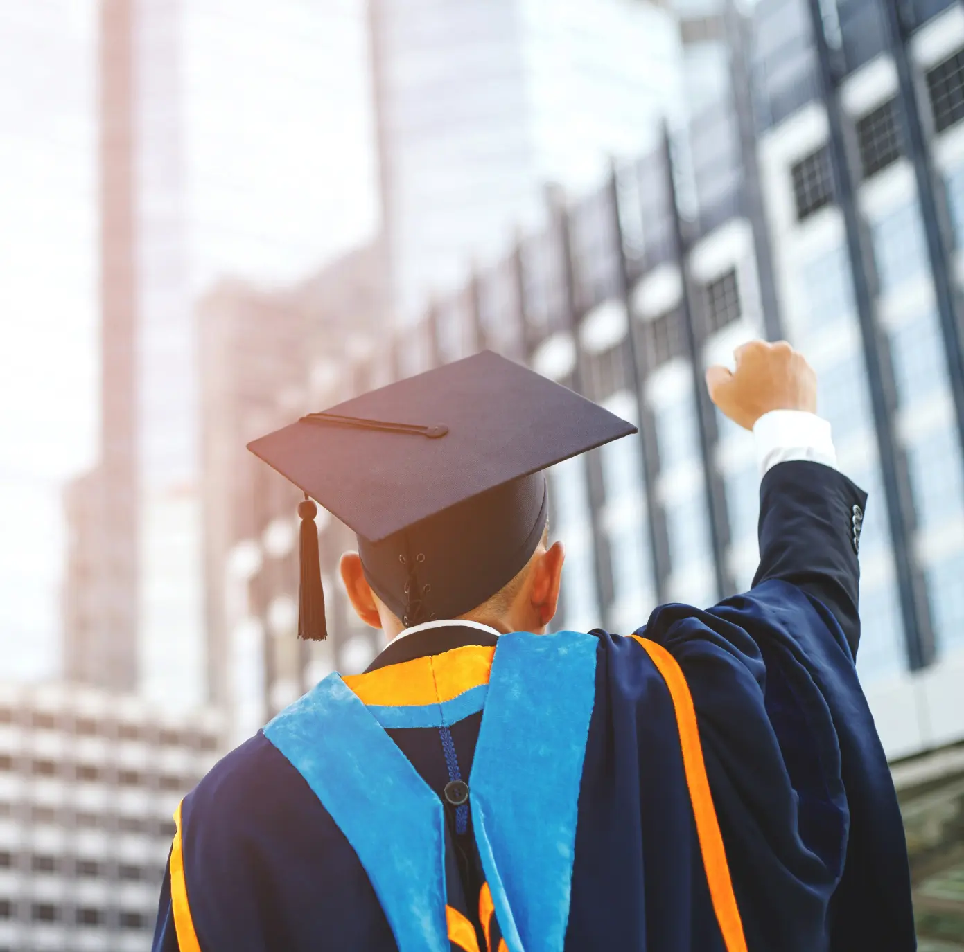 college graduate student standing infront of a building